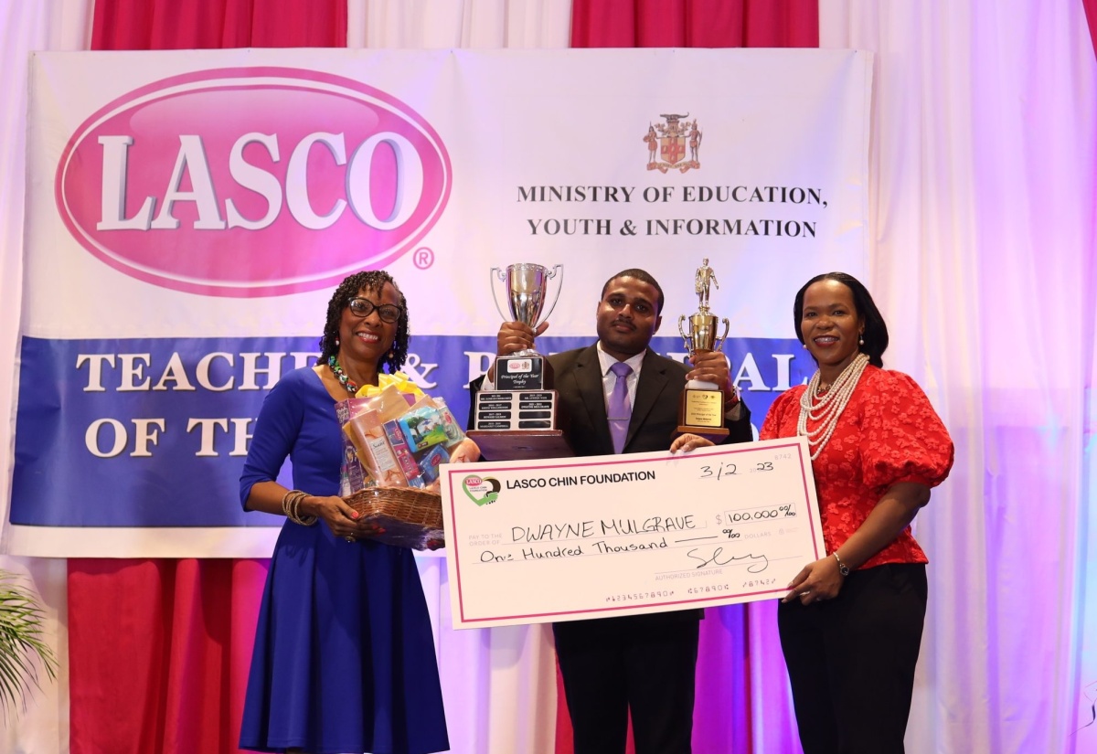 Principal of Discovery Bay High School, Dwayne Mulgarve (centre) is presented with the Principal of the Year prizes and awards by Acting Chief Education Officer in the Ministry of Education and Youth (MOEY), Dr. Kasan Troupe (right) and Chief Executive Officer of the LASCO Chin Foundation, Professor Rosalee Hamilton. The 2022/2023 LASCO/MOEY/JTC Principal and Teacher of the Year awards ceremony was held on Friday (Feb. 3), at the Jamaica Pegasus Hotel in New Kingston.