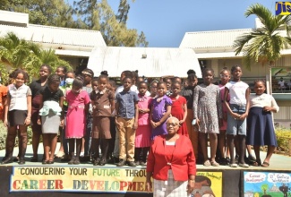 Principal of John Rollins Success Primary in St. James, Yvonne Miller-Wisdom, shares a photo moment with students on Career Day at the school,  on February 10.