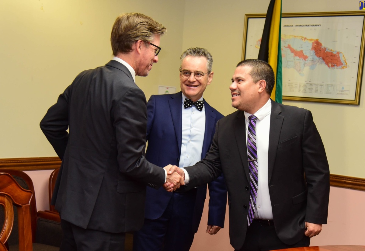 Minister without Portfolio in the Office of the Prime Minister (OPM), Senator the Hon. Matthew Samuda (right), shakes hands with French Economic Counsellor, Stephan Dubost (left), while Ambassador of France in Jamaica, His Excellency Olivier Guyonvarch, looks on. Occasion was a meeting at OPM on March 15, to discuss the continued cooperation on areas of sustainable development between France and Jamaica.