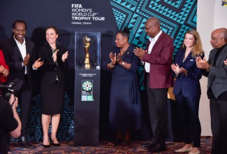 Minister of Culture, Gender, Entertainment and Sport, Hon. Oliva Grange (third left), applauds during a ceremony for the unveiling of the FIFA Women’s World Cup Trophy, at The Jamaica Pegasus hotel in New Kingston on Monday (April 17). She is joined by (from left) State Minister in the Ministry of Culture, Gender, Entertainment and Sport, Hon. Alando Terrelonge; Foreign Affairs and Foreign Trade Minister, Senator the Hon. Kamina Johnson Smith; President, Jamaica Football Federation (JFF), Michael Ricketts; FIFA Senior Manager, Trophy Tours, Sarah Gandoin and President, Jamaica Olympic Association (JOA), Christopher Samuda.