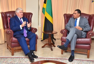 Prime Minister, the Most Hon. Andrew Holness (right), listens intently to founder and chairman of Digicel Group, Denis O’Brien, during a courtesy call at the Office of the Prime Minister (OPM) on Tuesday (April 25).