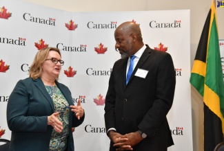 Director General of the Planning Institute of Jamaica (PIOJ), Dr. Wayne Henry, engages with High Commissioner of Canada to Jamaica, Her Excellency Emina Tudakovic, during the launch of the Local Engagement and Action Fund (LEAF) at The Jamaica Pegasus hotel in New Kingston on Thursday (April 20).