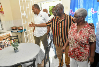 Minister of Local Government and Rural Development, Hon. Desmond McKenzie (second right) points to the fully appointed kitchen in the brand-new studio unit built specially for 64-year-old Shirley Nugent (right) during the recent handover ceremony in Hamilton Mountain, Oracabessa, St. Mary. It was constructed under the Ministry’s Indigent Housing Solution programme. Also pictured touring the unit are Mayor of Port Maria, Councillor Richard Creary (left) and Member of Parliament, St. Mary Western, Robert Montague.