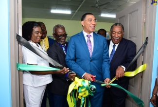 Prime Minister, the Most Hon. Andrew Holness (fourth left), cuts ribbon to open the new $53-million male ward at the Westmoreland Infirmary in Savanna-la-Mar, on April 26. Sharing the moment are (from left) Matron at the Infirmary, Nedene Collins-Whyte; Member of Parliament for Central Westmoreland, George Wright; Minister of Local Government and Rural Development, Hon. Desmond McKenzie and Mayor of Savanna-la-Mar, Councillor Bertel Moore.