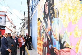 United Nations (UN) Secretary General, His Excellency, António Guterres (second right), listens as Mayor of Kingston, Senator Councillor, Delroy Williams (right), highlights the features of a cultural mural of reggae icon Bob Marley during a tour of the Artwalk in the Kingston Creative District, downtown Kingston. Others (from left) are Town Clerk, Kingston and St. Andrew Municipal Corporation (KSAMC), Robert Hill and former State Minister in the Ministry of Culture, Gender Entertainment and Sport, Hon. Alando Terrelonge.