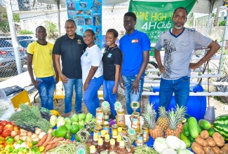 Minister of Agriculture, Fisheries and Mining, Hon. Floyd Green (second left), with representatives from the Papine High School 4-H Club during the 2023 Agricultural Show (Agrofest) for Kingston and St. Andrew. They are (from left) students, Andrew Matthewson, Grade 10; Jessica Williamson, Grade 11; Rihanna Simpson, Grade 11, and Terome Rookwooe, Grade 10; and Agricultural Science teacher, Mark Jones. The event was held on the Ministry’s playfield in Kingston, on Saturday (May 27).