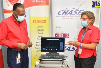 Chief Executive Officer, Culture, Health, Arts, Sports and Education (CHASE) Fund, W. Billy Heaven, and Executive Director, Heart Foundation of Jamaica (HFJ), Deborah Chen, converse following the recent handover of an echocardiogram machine to the HFJ in Kingston.