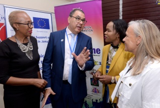 Minister of Education and Youth, Hon. Fayval Williams (left), listens as Director of The Arrow Foundation, Christopher Bonterre (second left), outlines the entity’s activities during Tuesday’s (May 2) launch of Literacy Education Acceleration Programme (LEAP) pilot, at the Holy Trinity High School in Kingston. Also listening are Chief Education Officer (Acting) in the Ministry, Dr. Kasan Troupe (second right) and Head of the European Union Delegation to Jamaica, Belize, The Bahamas, Turks and Caicos Islands and Cayman Islands, Her Excellency Ambassador Marianne Van Steen.