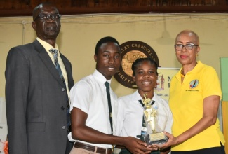 Minister of Education and Youth, Hon. Fayval Williams (right) presents the winning trophy in the 'Just Medz It' jingle competition to Vere Technical High School. Accepting are Head Boy, O'Neil Grant, and Head Girl, Derricka Wolf, while Acting Principal, O'Neil Lewin, shares the moment. The awards ceremony was held at the institution in Clarendon on May 19. The jingle competition formed part of a year-long End Violence in Schools campaign to showcase the talents of students and their creativity in promoting non-violent means of resolving conflicts. 