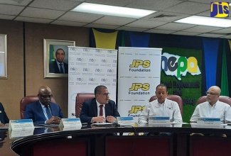 Minister Without Portfolio in the Ministry of Economic Growth and Job Creation, Senator the Hon. Matthew Samuda (second left), delivers remarks during the signing ceremony for the National Environment and Planning Agency (NEPA) ‘Adopt-A-Mangrove’ programme. The ceremony was held at NEPA’s head office in Kingston on Thursday (May 18). Listening (from left) are NEPA’s Chief Executive Officer, Peter Knight; Chief Operating Officer, Jamaica Public Service (JPS) Company Limited, Gary Barrow and Deputy Chairman, JPS Foundation Limited, Ramsay McDonald. 