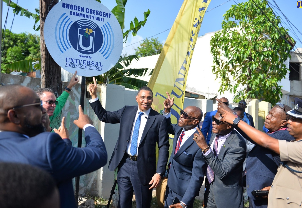 Prime Minister, the Most Hon. Andrew Holness (third right), points to the sign for the free secured community Wi-Fi at Rhoden Crescent in Penwood, St. Andrew West Central, at the launch of the service on May 11. He is joined by (from left) Principal, Penwood High School, Omar Largie; Minister of Science, Energy and Technology, Hon. Daryl Vaz; Custos of St. Andrew, Ian Forbes; Chief Executive Officer, Universal Service Fund (USF), Daniel Dawes; Councillor Caretaker, Molynes Division, Glendon Salmon and Commanding Officer, St. Andrew South Division, Superintendent of Police, Kirk Ricketts.