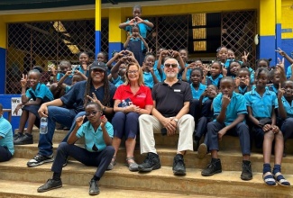 Event Marketer, Sean “Contractor” Edwards (left, second row), along with Issa Trust Foundation President, Diane Pollard (second left, second row) and Chairman, Paul Issa (third left, second row), are with students of Bob Marley Primary and Junior High School in Stepney, St. Ann.