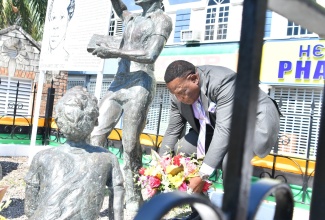 Mayor of Montego Bay, Councillor Leeroy Williams, lays a floral arrangement at the statue of National Hero, The Right Excellent Samuel Sharpe during the  annual Floral Tribute ceremony held in Sam Sharpe Square on Labour Day, Tuesday (May 23).