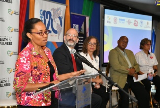 Acting Permanent Secretary in the Ministry of Health and Wellness, Paulette Spencer Smith (left), addresses the World No Tobacco Day Youth Forum on Wednesday (May 31), at The Jamaica Pegasus hotel in New Kingstown. Listening (from second left) are PAHO/WHO Country Representative, Ian Stein;  Executive Director, Physical Therapy Solutions, Dr. Bernadette Bryan Frankson; Executive Director, National Council on Drug Abuse (NCDA), Michael Tucker and Executive Director, Heart Foundation of Jamaica, Deborah Chen. 