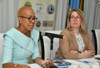 Minister of  Education and Youth,  Hon. Fayval Williams (left), addresses the opening ceremony of the national seminar, ‘Tackling the Presence of Firearms in Schools’, held on June 1 at the Spanish Court Hotel in Kingston. Also pictured is Director of the United Nations Regional Centre for Peace, Disarmament and Development in Latin America and the Caribbean (UNLIREC), Soledad Urruela.