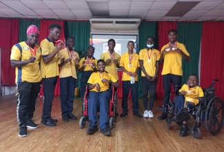Members of Genesis Academy’s sports team, which copped over 20 medals and ribbons at the Special Olympics Jamaica National Games in Kingston. From left are Coach, Wayne Roberts; Nickoi Jones; Delano Gunter; Britany Martin; Omario Christian; Coyou Allen; Mathew Pusey; Brandon Graham; Assistant Coach, Dane Brown; and Maurice Dyer (centre). 