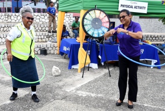 Chief Medical Officer (CMO), Dr. Jacquiline Bisasor-McKenzie (right), along with member of the Ministry of Health and Wellness Emergency Management team, Shirley Marshal Davis, engages in a physical activity during yesterday’s (June 1) Caribbean Nutrition Day, held at the St. William Grant Park in downtown Kingston.