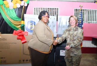 Regional Director, Region 4, in the Ministry of Education and Youth, Dr. Michelle Pinnock (left), greets Combatant Commander, United States Southern Command, General Laura Richardson, at the handover of information and communications technology (ICT) equipment to three St James schools at Spot Valley High in the parish, on June 6.

