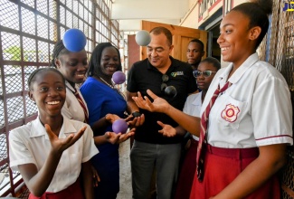 Minister of Health and Wellness,  Dr. the Hon. Christopher Tufton (centre), engages in a stress-relief exercise with students of Denham Town High School in Kingston on Tuesday (June 6) as part of the Ministry’s School Mental Health Literacy Programme. Joining in the activity is Guidance Counsellor of the school, Dawn Scott-Turner (third left).