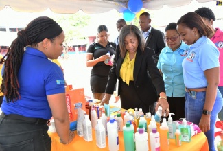 Wife of the Governor-General, Her Excellency, the Most Hon. Lady Allen (third right), examines products being displayed by Facey Pharmaceutical during a health fair and open day at the Bustamante Hospital for Children on May 31, to commemorate the institution’s 60th anniversary. Looking on (from left) are Facey Pharmaceutical Sales Ambassador, Olivia Pyne; the Hospital’s Senior Medical Officer (SMO), Dr. Michelle-Ann Richards Dawson, and ENT Consultant, Dr. Marsha James. 