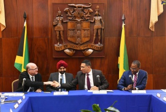 Prime Minister, the Most Hon. Andrew Holness (second right), shakes hands with President of the Inter-American Development Bank, Ilan Goldfajn (left), during a meeting at Jamaica House on June 14. They are joined by President of the World Bank, Ajay Banga (second left) and Minister of Finance and the Public Service, Dr. the Hon. Nigel Clarke.