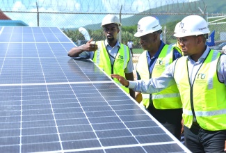 Minister of Agriculture, Fisheries and Mining, Hon. Floyd Green (right) and State Minister, Hon. Franklin Witter (centre), inspect solar panels comprising the Plumwood Pumping Station PV Solar System Installation Project in New Forest, Manchester, along with Energy Engineer, National Irrigation Commission, Emile Myers. The facility, which was handed over by the Jamaica Social Investment Fund (JSIF) during a recent ceremony, was financed under the second cycle of the Rural Economic Development Initiative (REDI-II). The system will benefit approximately 1,943 farmers in the New Forest/Duff House Agro-Parks in South Manchester and South St. Elizabeth. 