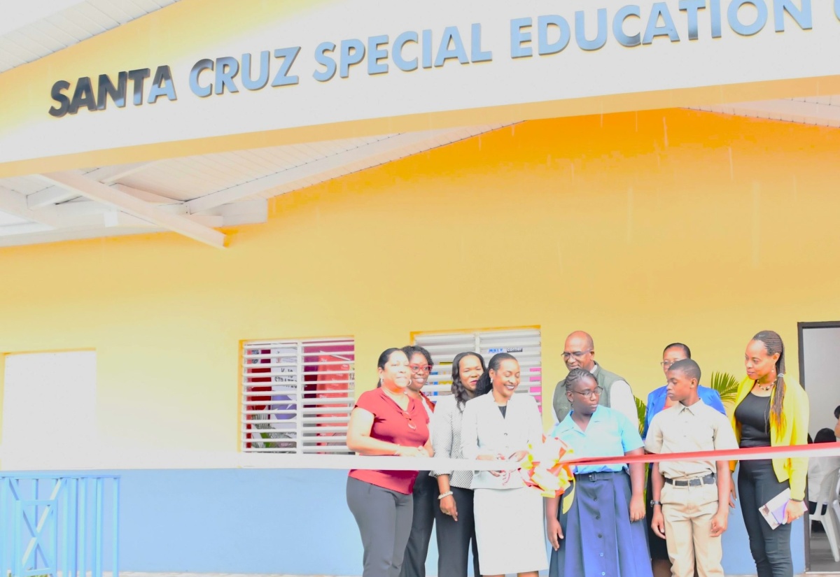 Minister of State in the Ministry of Education and Youth, Hon. Marsha Smith (fourth from left) cuts the ribbon to officially open the Santa Cruz Special Education Centre in St. Elizabeth on Thursday (June 8). Joining her (from left) are: Chief Executive Officer of the Digicel Foundation, Charmaine Daniels; Acting Director of Regional Education Services at the Ministry of Education and Youth – Region 5,  Nevadeene Gallimore Miller; Acting Chief Education Officer, Dr. Kasan Troupe; Member of Parliament for St. Elizabeth Northeast, Delroy Slowley; Centre Manager at the Santa Cruz Special Education Centre, Euphemia Kerr; Principal of the Woodlawn School of Special Education, Racquel Rhoden-South and students of the Woodlawn School of Special Education in the parish. 