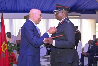 Governor-General, His Excellency the Most Hon. Sir Patrick Allen (left), presents Assistant Commissioner, Jamaica Fire Brigade, Julian Davis Buckle, with the 2022 Queen’s Platinum Jubilee Medal during a ceremony hosted by the JFB at the Terra Nova All-Suite Hotel in St. Andrew, on August 10. Mrs. Davis Buckle has given 27 years of service to the Brigade.