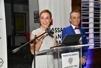 Minister of Foreign Affairs and Foreign Trade, Senator the Hon. Kamina Johnson Smith, addresses guests attending a soirée hosted at the French Embassy in St. Andrew on July 14 to commemorate the 234th anniversary of France’s National Day – Fête Nationale Française (Bastille Day). Listening is France’s Ambassador to Jamaica, His Excellency Olivier Guyonvarch.