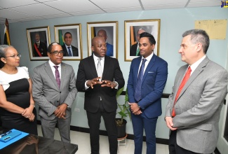 Minister of Labour and Social Security, Hon. Pearnel Charles Jr (centre), makes a point to the Inter-American Development Bank (IDB) Division Chief, Social Protection and Health, Pablo Ibarraran (right), during a courtesy call at the Ministry’s North Street offices in Kingston on July 17. Others (from left) are Permanent Secretary in the Ministry, Colette Roberts Risden; State Minister in the Ministry, Dr. the Hon. Norman Dunn and General Manager, Country Department Caribbean Group and Country Representative in Jamaica, IDB, Tariq Alli.