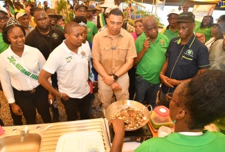 Prime Minister, the Most Hon. Andrew Holness (third left), views value-added products on display at the 69th Denbigh Agricultural, Industrial and Food Show, on Monday (August 7), at the Denbigh Showground in Clarendon. Others pictured (from left) are National Farm Queen, Samantha McLean; Minister of Agriculture, Fisheries and Mining, Hon. Floyd Green; Minister of State in the Ministry, Hon. Franklyn Witter, and Acting Executive Director of the Jamaica 4-H Clubs, Garfield Ewart.