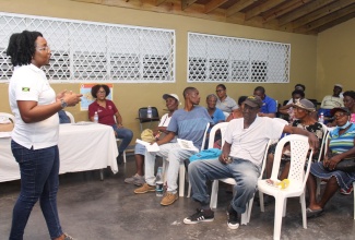 Project Manager, Office of Disaster Preparedness and Emergency Management (ODPEM), Lajean Powell-Richards, addresses residents of Old Harbour Bay at a community sensitisation meeting on June 26.