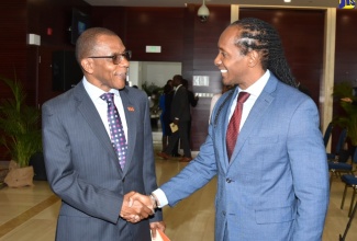 Minister of State, Ministry of Foreign Affairs and Foreign Trade, Hon. Alando Terrelonge (right) shakes hands with President of the VM Group, Courtney Campbell, during the launch ceremony of the Global Jamaica Diaspora Council (GJDC) and the Global Jamaica Diaspora Youth Council (GJDYC) on June 29 at the Ministry in Kingston.