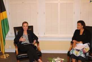 Minister of Foreign Affairs and Foreign Trade, Senator the Hon. Kamina Johnson Smith (left), addresses the online town hall meeting, ‘Let’s Connect with Ambassador Audrey Marks,’ held recently at the Embassy of Jamaica in Washington DC. Jamaica’s Ambassador to the United States (US), Her Excellency Audrey Marks, listens. (Photo Derrick Scott)