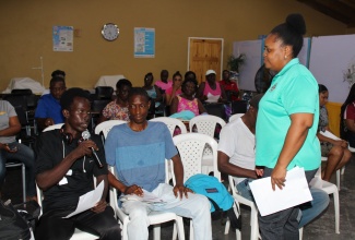 Senior Director, Preparedness and Emergency Operations Division (Acting), ODPEM, Sophia Mitchell, interacts with residents of Old Harbour Bay at a community sensitisation meeting on June 26.