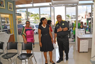 Minister of State in the Ministry of Education and Youth and Member of Parliament for St. Ann Northeastern, Hon. Marsha Smith (centre), and Speaker of the House of Representatives, Marisa Dalrymple-Philibert (left) are led on a tour of the new Passport, Immigration and Citizenship Agency (PICA) office in St. Ann’s Bay, St. Ann, by Chief Executive Officer of the agency, Andrew Wynter. Occasion was the official opening of the facility at 8 Park Avenue, on Friday, August 11.