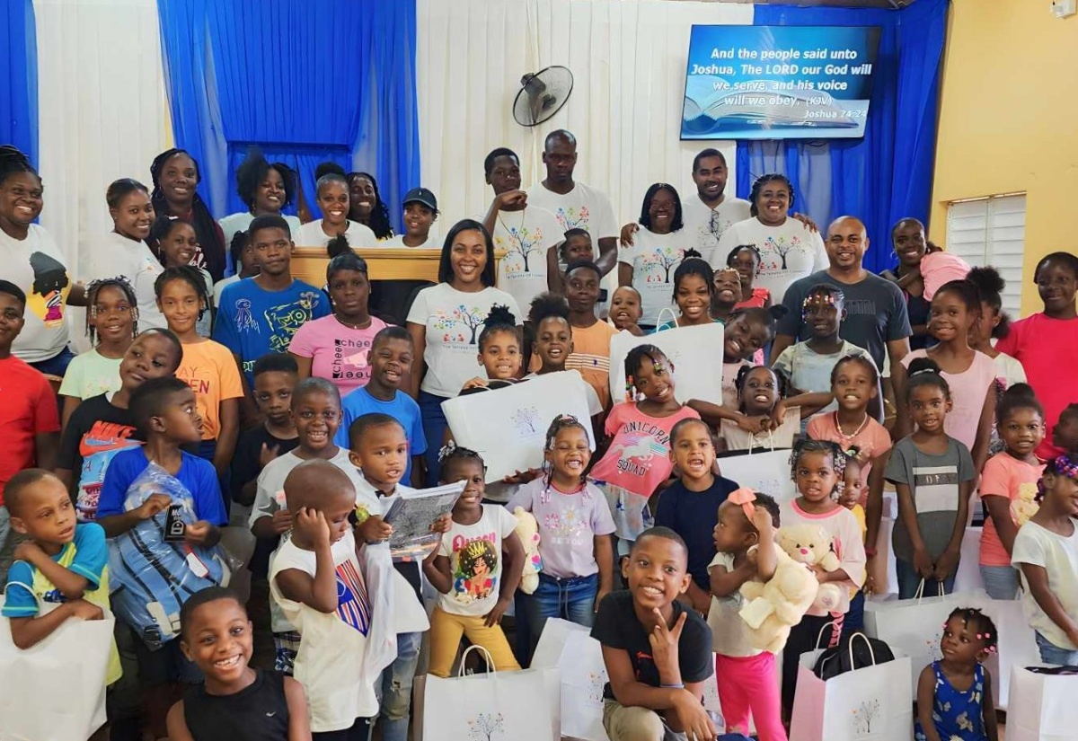 Children from Mount Moreland and surrounding communities in St. Catherine with their educational gifts at a back-to-school treat organised by the Tameka Hill Foundation on July 29, at the Mount Moreland Church of God of Prophecy.