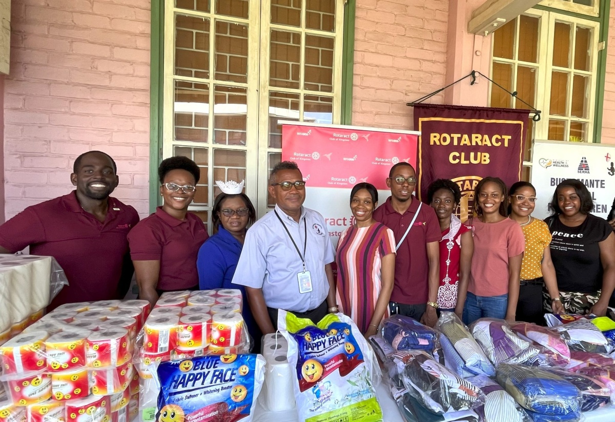 President of the Rotaract Club of Kingston (RCOK), Natasha Burnett (left), along with Director of Nursing Services at the Bustamante Hospital for Children (BHC), Beverly Senior-Berry (third left)), Chief Executive Officer of the hospital, Anthony Wood (fourth left), and other members of the Club at the recent handover of  care items by the Club to the  hospital, in St. Andrew.