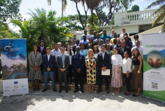 Local Government and Community Development Minister, Hon. Desmond McKenzie (front, fourth left), is surrounded by participants in a regional technical workshop on waste management and environmental sustainability.  The three-day session, which concludes on Thursday (September 14), is being held virtually and in-person.   

