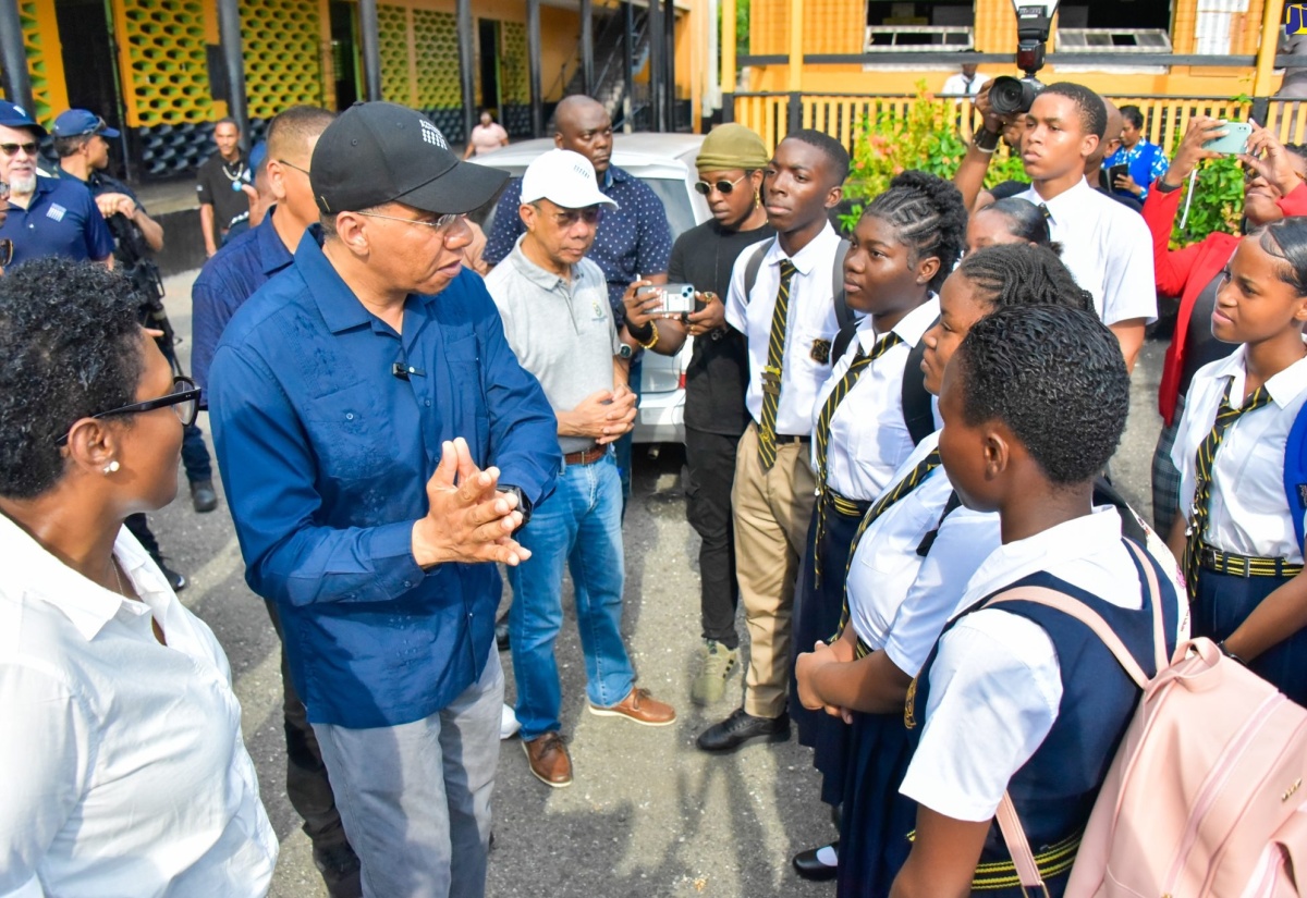 Prime Minister, the Most Hon. Andrew Holness (second left), interacts with students of Kingston Technical High School on Friday (September 15) during a visit to the institution while touring several communities in downtown Kingston where the Project STAR (Social Transformation and Renewal) initiative is being implemented. The Prime Minister is accompanied by (from left) President and Chief Executive Officer, Scotia Group Jamaica, Audrey Tugwell Henry, and Deputy Prime Minister and Minister of National Security, Hon. Dr. Horace Chang.