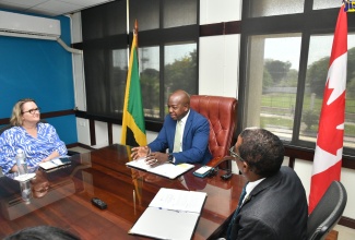 Minister of Labour and Social Security, Hon. Pearnel Charles Jr. is in discussion with High Commissioner of Canada to Jamaica, Her Excellency Emina Tudakovic (left), during a courtesy call at the Ministry’s Heroes Circle offices in Kingston recently. At right is Minister of State in the Ministry, Dr. the Hon. Norman Dunn. 