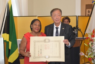 Ambassador of Japan to Jamaica, His Excellency Yasuhiro Atsumi, presents a citation to former Ambassador of Jamaica to Japan, Her Excellency Claudia Cecile Barnes. Occasion was a ceremony for the conferment of the Order of the Rising Sun, Gold and Silver Star, on Ambassador Barnes, at the official residence of the Ambassador of Japan in St. Andrew on September 20. The Order of the Rising Sun is conferred by the Government of Japan on persons who have rendered outstanding service to the nation or the public, including foreign nationals who made significant contributions in advancing relations between Japan and its partners.

 