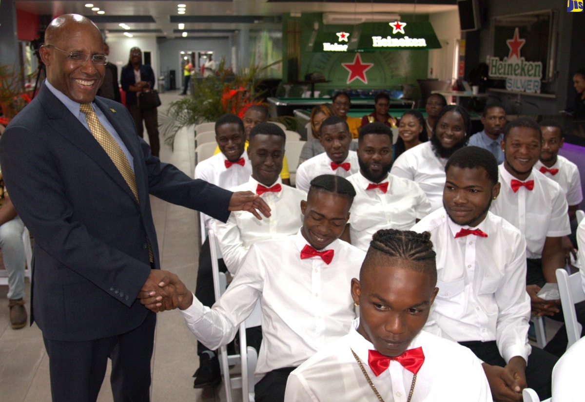 Industry, Investment and Commerce Minister, Senator the Hon. Aubyn Hill (left), congratulates Desnoes and Geddes (D&G) Foundation’s Forklift Operator training and certification programme participant, Jason Rose, during the graduation ceremony held on September 21 at the Red Stripe Plant in Kingston.

