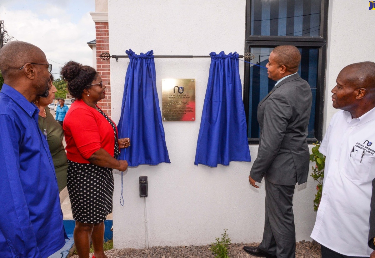 Minister of Agriculture, Fisheries and Mining, Hon. Floyd Green (second right), and Board Member, National Irrigation Commission Limited (NIC), Theresa Turner-Flynn (second left), unveil the plaque for the National Irrigation Commission Limited (NIC) Operations Centre and Rio Cobre Office in St. Catherine, during the commissioning ceremony on Wednesday (September 13). Looking on (from left) are NIC Chief Executive Officer, Joseph Gyles, and Chief Technical Director, Special Projects, Ministry of Agriculture, Fisheries and Mining, Courtney Cole.