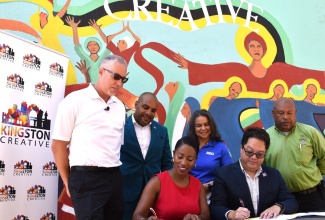 Kingston Creative Executive Director, Andrea Dempster-Chung (seated left), and Expedia Group Senior Business Development Manager, Warren Ho (seated right), affix their signatures to an agreement that will facilitate Jamaica’s participation in Expedia Group’s Sustainability Giveback programme, on Wednesday (September 13) on Water Lane in Kingston. Observing the signing (from left) are Jamaica Tourist Board (JTB) Acting Deputy Director of Tourism for the Americas, Philip Rose; Chief Executive Officer of the Kingston and St. Andrew Municipal Corporation, Robert Hill; JTB Manager of Tour Operators and Airlines, Francine Carter Henry; and Deputy Mayor of Kingston and St. Andrew, Winston Ennis. Kingston Creative received a donation of US$15,000 from the Expedia Group in association with the Jamaica Tourist Board (JTB). Kingston Creative was selected, on the recommendation of the JTB, to be awarded the Expedia Sustainability Grant for 2023 to support its work in community tourism and the wider cultural and creative industries.