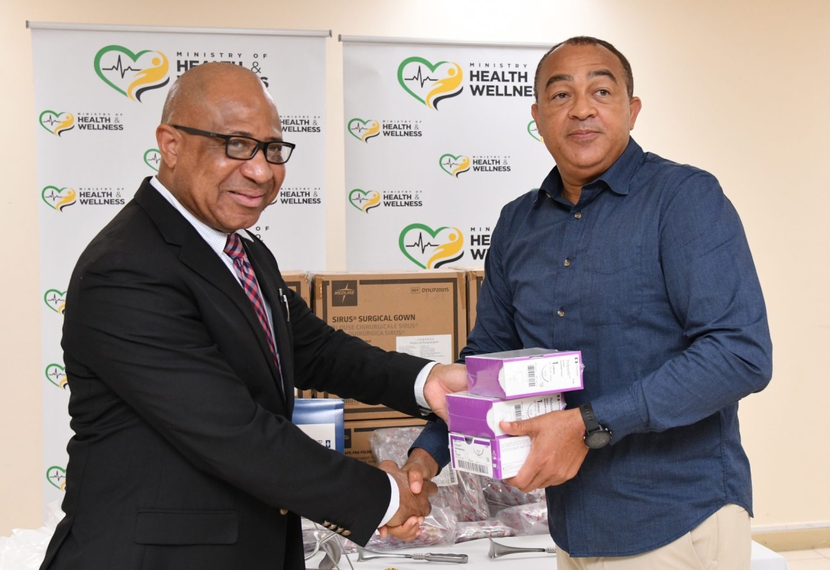 Minister of Health and Wellness, Dr. the Hon. Christopher Tufton (right), hands over medical supplies to Regional Director, Western Regional Health Authority, St. Andrade Sinclair. Occasion was the presentation of surgical sets and other medical disposables to the island’s regional health authorities at the Ministry’s corporate offices in New Kingston on September 6.