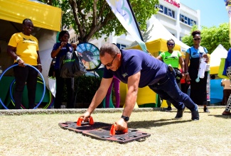 Minister of Health and Wellness, Dr. the Hon. Christopher Tufton, demonstrates his physical fitness during a Caribbean Wellness Day event on Friday (September 8), at the VMBS grounds on Knutsford Boulevard in New Kingston.