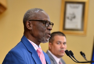 Minister of Local Government and Community Development, Hon. Desmond McKenzie (left), addresses today’s (September 13) post-Cabinet press briefing at Jamaica House, in St. Andrew. Listening is Minister without Portfolio in the Ministry of Economic Growth and Job Creation, Senator the Hon. Matthew Samuda.

