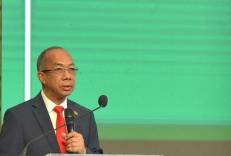 Deputy Prime Minister and Minister of National Security, Hon. Dr. Horace Chang, addresses Tuesday’s (September 19) opening of the 37th International Drug Enforcement Conference (IDEC) at the Montego Bay Convention Centre in Rose Hall, St. James. Seated in the background is US Ambassador to Jamaica, Nick Perry.