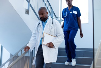 Doctors walking down hospital staircase
